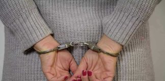 Person in handcuffs with gray sweater