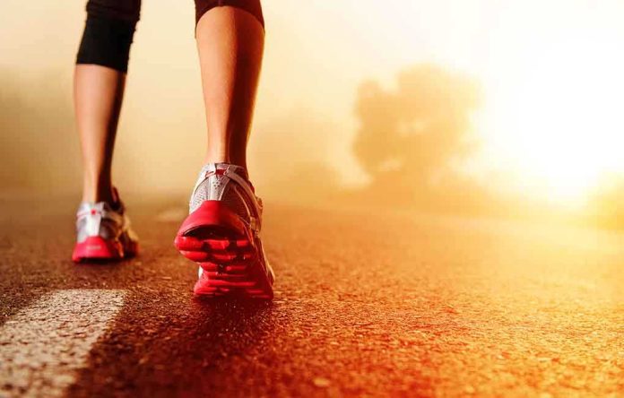 shutterstock_106892909.jpg Person jogging on a road during sunrise