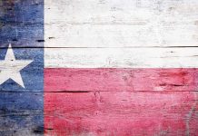 Texas flag displayed on a wooden background