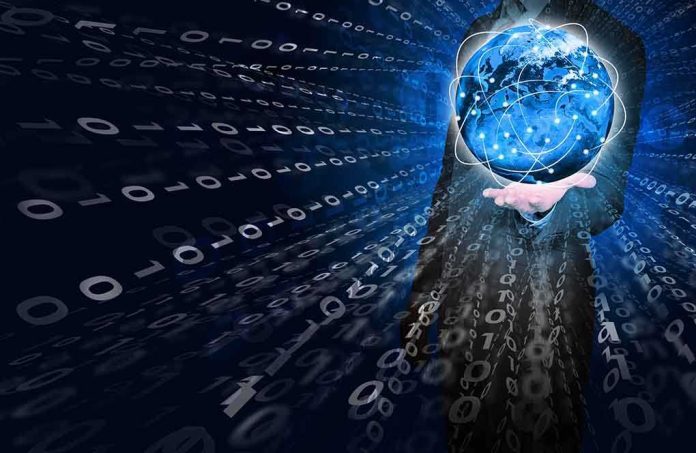shutterstock_196320203.jpg A businessman holding a glowing globe surrounded by binary code