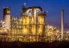 An industrial facility with illuminated structures at night