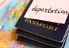 Stack of passports with a note labeled 'deportation' on top, placed on a map