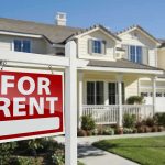 A house with a For Rent sign in the front yard