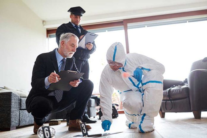 1455188570 Forensic team examining evidence at a crime scene indoors.