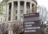 Federal Trade Commission Building with sign and trees.