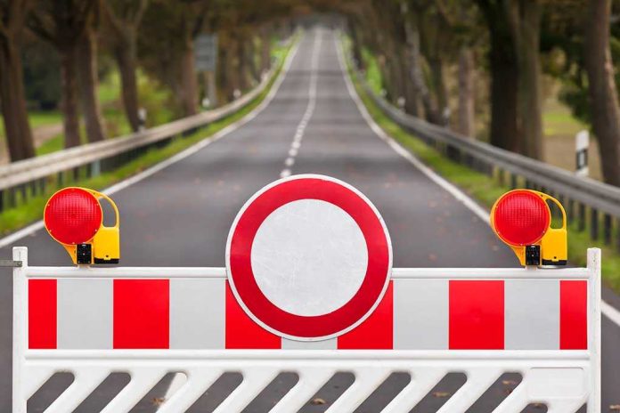 shutterstock_222258445.jpg Traffic barrier with a red and white sign blocking a road