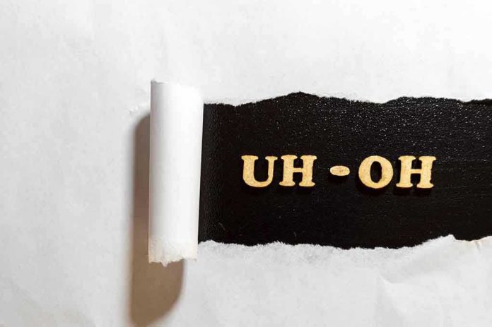 1135625576 Torn paper revealing UH-OH text underneath.