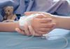 HORRIFYING Child Euthanasia Laws SPREAD! Childs hand with IV, held by adult.