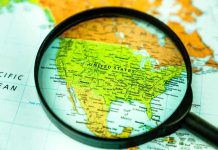 Newsom’s Power Grab BACKFIRES Spectacularly Magnifying glass over United States on map.