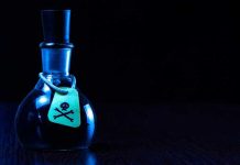 Fortified Death Factories TARGET American Streets Dark bottle with skull-and-crossbones label on table.