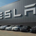 Serious Safety Alert — Tesla’s EVs in Crisis Tesla facility with parked cars in front.