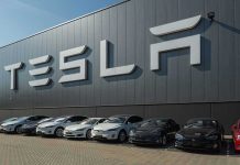 Serious Safety Alert — Tesla’s EVs in Crisis Tesla facility with parked cars in front.