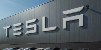 Serious Safety Alert — Tesla’s EVs in Crisis Tesla facility with parked cars in front.