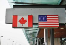 Trump vs. Canada Over FAKE Ad Canadian and American flags displayed at a border crossing