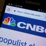Close-up of a smartphone displaying the CNBC website