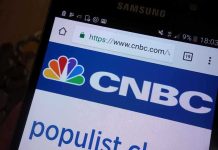 Close-up of a smartphone displaying the CNBC website