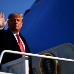 Trump Targeted AGAIN — Shocking Security Breach A political figure waving while standing on the steps of airforce one