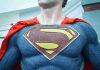 Close-up of a Superman statue wearing a blue costume and red cape