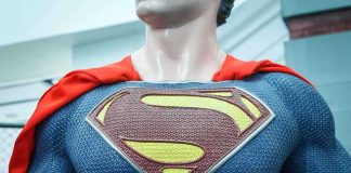 Close-up of a Superman statue wearing a blue costume and red cape