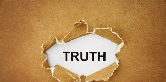 A piece of torn paper revealing the word TRUTH underneath