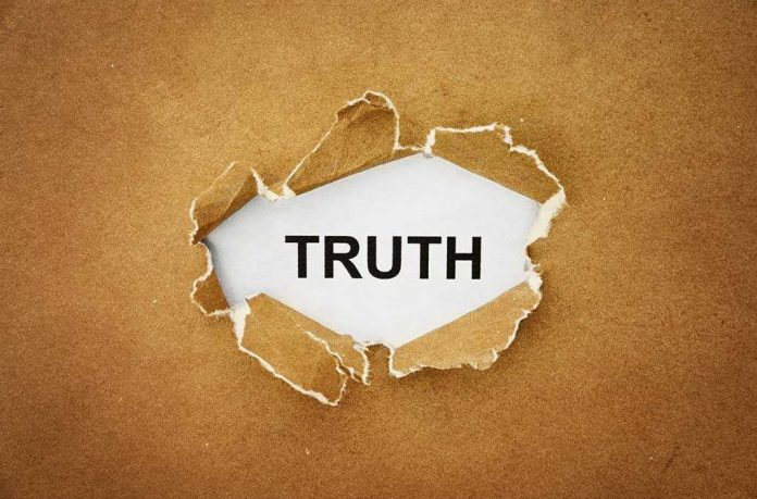 shutterstock_211611715.jpg A piece of torn paper revealing the word TRUTH underneath