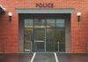 Family Betrays Relative — SAVES Countless Lives Entrance of a modern police station with brick facade