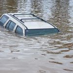 Rescue Drama — Homes Washed Away A partially submerged vehicle in floodwaters