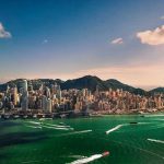 Aerial view of a coastal city with skyscrapers.