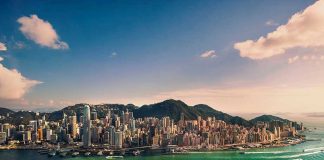 Aerial view of a coastal city with skyscrapers.