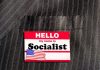 Seattle’s Socialist Mayor Stuns with Bold Agenda Hello my name is Socialist name tag on suit.