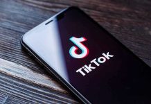 Phone screen showing TikTok logo and app.