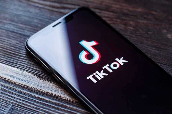 1455492983 Phone screen showing TikTok logo and app.