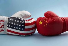 China’s SHOCKING Retaliation Rocks American Economy USA and China boxing gloves facing each other.
