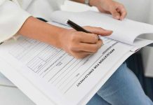 Tech Giant ABANDONS College System Entirely Person filling out job application form.