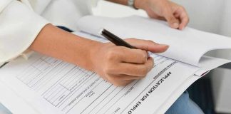 Tech Giant ABANDONS College System Entirely Person filling out job application form.