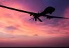 Frontline Shock: Women Command Drones Silhouette of a drone against a colorful sunset.