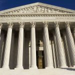 Facade of the Supreme Court building featuring tall columns and intricate carvings