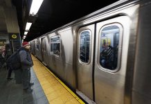 SHOCKING TRAIN BLOODBATH — Nine Critical A commuter waiting at a subway station as a train approaches