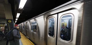 SHOCKING TRAIN BLOODBATH — Nine Critical A commuter waiting at a subway station as a train approaches