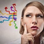 Thoughtful woman with colorful arrows representing choices and decisions