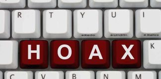 Close-up of a computer keyboard with the word HOAX spelled out in red keys