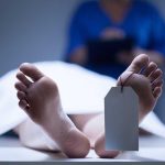 Shocking ‘Unaliving’ Casket Plants A deceased body on a table with a tag on the foot, and a medical professional in the background