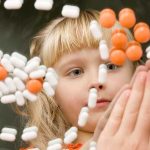 ADHD Debate: What They’re Not Telling You A child observing colorful pills floating in the air