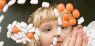 A child observing colorful pills floating in the air