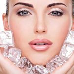 Lip Filler Trip Ends in Hot-Car Horror Woman holding ice cubes near her face.