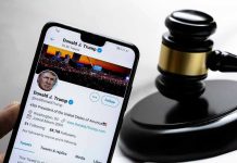 President Trump Sets Roger Stone Free Smartphone displaying Twitter profile near a judges gavel.