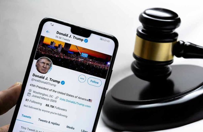 1889360596 Smartphone displaying Twitter profile near a judges gavel.