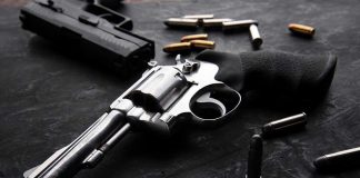 Gunfire at Bojangles: Shocking Workplace Violence Revolvers and bullets on a dark surface.