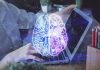 Travel Nightmare: AI Sends Tourists to Dangerous Zones Futuristic AI brain hologram above a laptop computer.