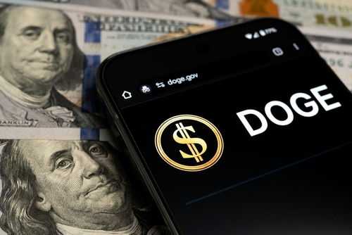 2591039935 Smartphone displaying Doge logo on hundred dollar bills